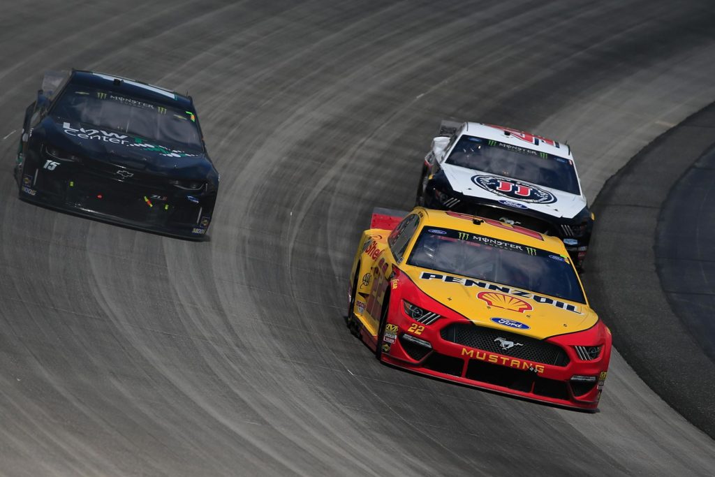Joey Logano and Kevin Harvick pass Ross Chastain in the Gander RV 400 at Dover International Speedway.