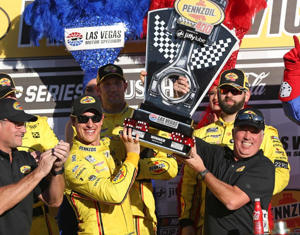 Joey Logano celebrates in victory lane after winning the Pennzoil 400